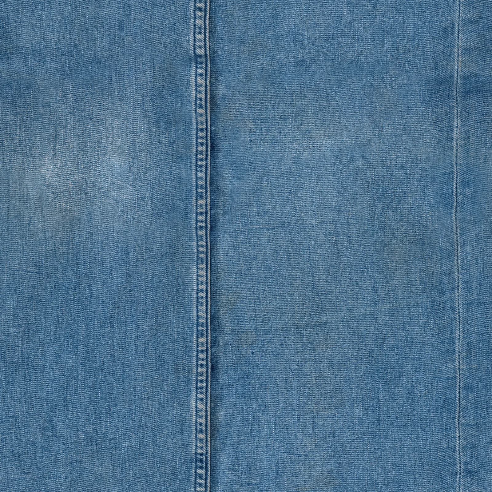 Close-up of indigo denim fabric with a stitched seam